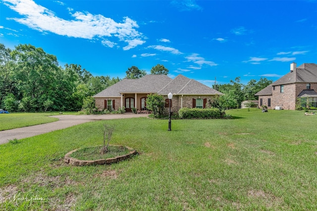 view of front of house with brick siding and a front lawn
