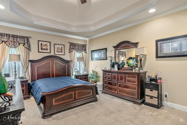 carpeted bedroom featuring ornamental molding, multiple windows, and a raised ceiling