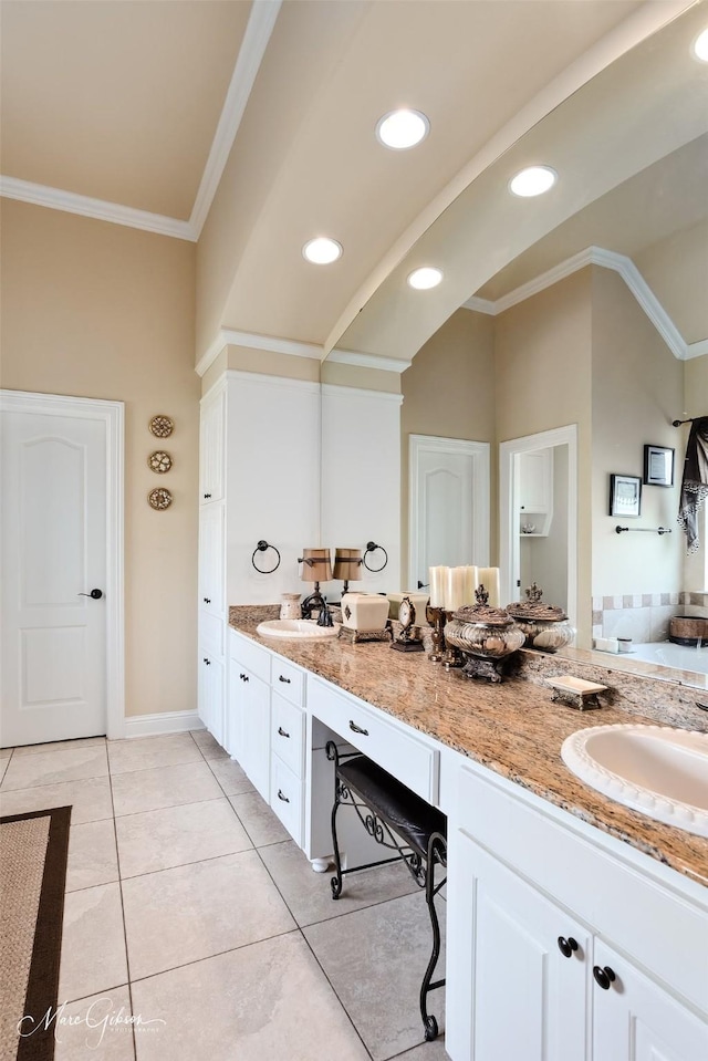 full bathroom with ornamental molding, a sink, double vanity, and tile patterned floors