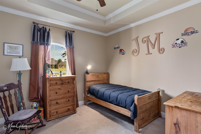 carpeted bedroom featuring ornamental molding, a ceiling fan, a raised ceiling, and baseboards