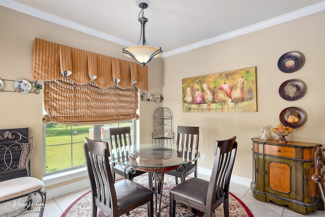 tiled dining space featuring baseboards and ornamental molding