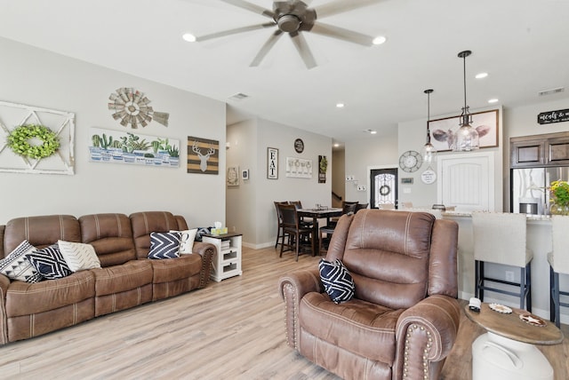 living area with visible vents, light wood-style flooring, ceiling fan, and recessed lighting