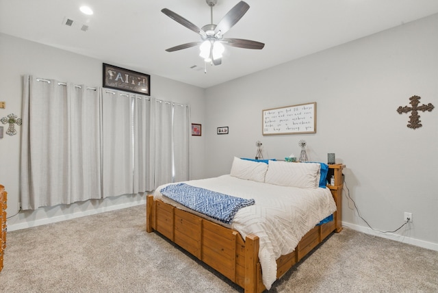bedroom featuring light carpet, baseboards, visible vents, and ceiling fan