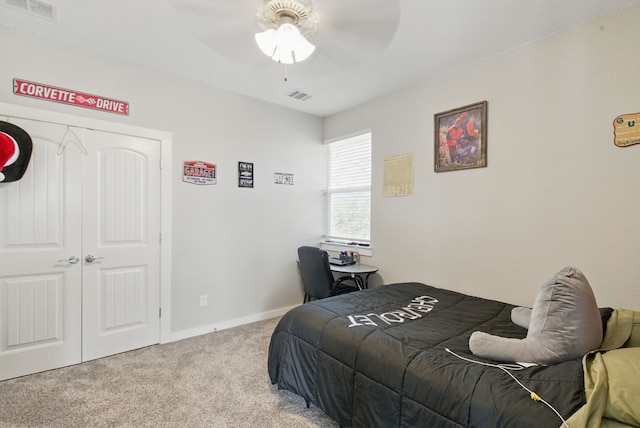 bedroom with baseboards, visible vents, a closet, and light colored carpet