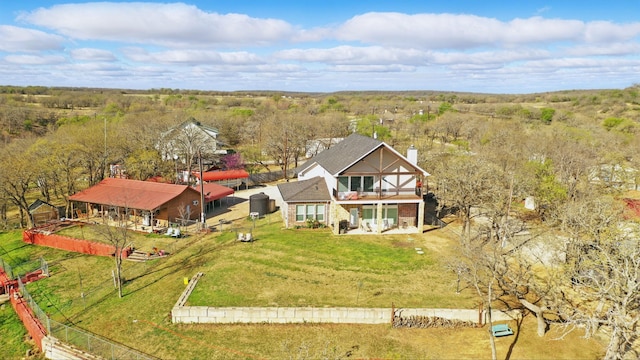 birds eye view of property featuring a wooded view