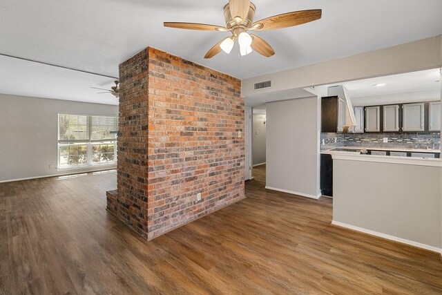 unfurnished living room with visible vents, baseboards, ceiling fan, and wood finished floors