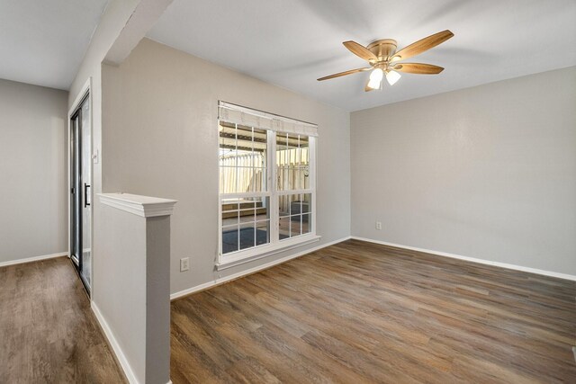 spare room with baseboards, a ceiling fan, and wood finished floors