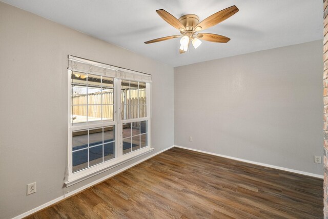 unfurnished room featuring a ceiling fan, baseboards, and wood finished floors
