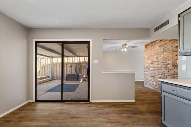kitchen featuring visible vents, a ceiling fan, gray cabinets, and dark wood-style floors
