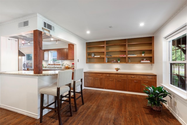 6814 Blackwood Dr, Dallas, TX 75231 - kitchen with brown cabinets, dark wood-type flooring, open shelves, a breakfast bar, and ornamental molding