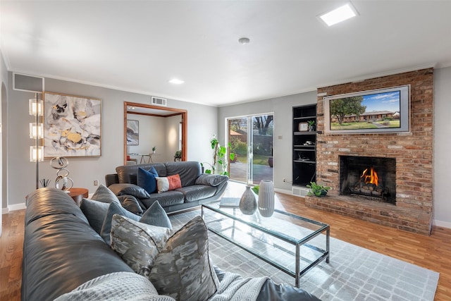 6814 Blackwood Dr, Dallas, TX 75231 - living area featuring wood finished floors, ornamental molding, a brick fireplace, and baseboards