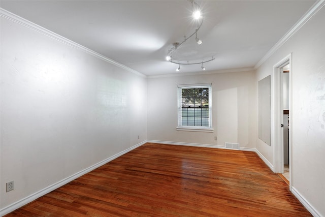 6814 Blackwood Dr, Dallas, TX 75231 - spare room featuring wood finished floors, crown molding, track lighting, and baseboards