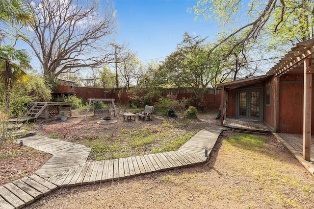 6814 Blackwood Dr, Dallas, TX 75231 - fenced backyard featuring french doors and a wooden deck