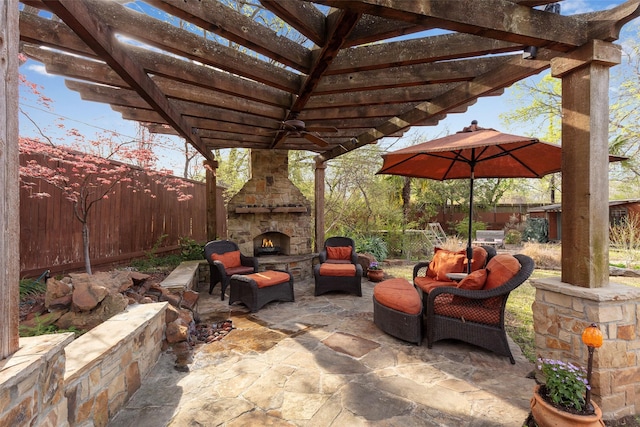 6814 Blackwood Dr, Dallas, TX 75231 - fenced backyard with an outdoor stone fireplace, a pergola, and a patio