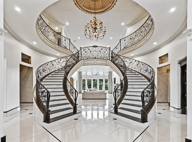 foyer entrance with recessed lighting, stairway, ornamental molding, and an inviting chandelier