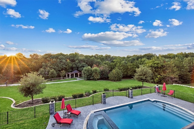view of pool with fence, a yard, a fenced in pool, and a gazebo