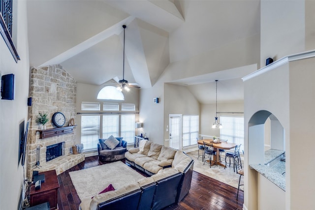 3533 Hutch Dr, Plano, TX 75074 - living area featuring high vaulted ceiling, a fireplace, ceiling fan with notable chandelier, and dark wood-type flooring