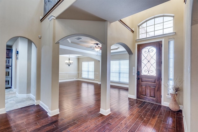 3533 Hutch Dr, Plano, TX 75074 - foyer featuring arched walkways, a ceiling fan, wood finished floors, and visible vents