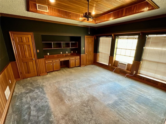 interior space with light colored carpet, visible vents, wooden ceiling, and a raised ceiling