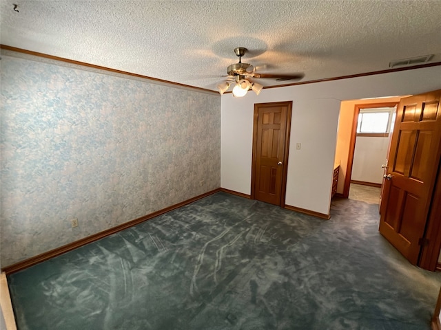unfurnished bedroom featuring wallpapered walls, a textured ceiling, baseboards, visible vents, and dark carpet