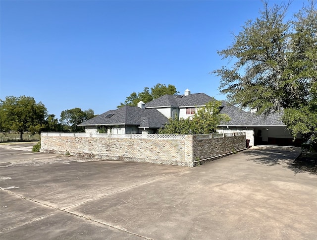 view of side of home with a fenced front yard