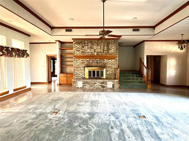 unfurnished living room with ceiling fan, crown molding, a fireplace, and visible vents