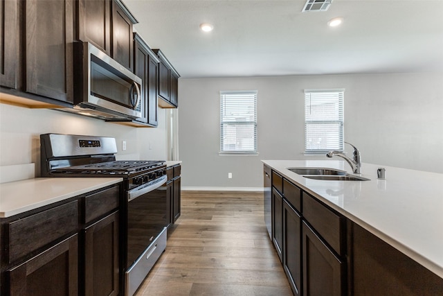 2004 Saddle Way, Mesquite, TX 75149 - kitchen featuring visible vents, a sink, light countertops, dark brown cabinets, and stainless steel appliances