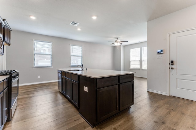 2004 Saddle Way, Mesquite, TX 75149 - kitchen featuring gas stove, a ceiling fan, visible vents, a healthy amount of sunlight, and a sink