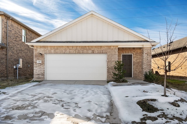 417 Covington Cv, Princeton, TX 75407 - view of front facade featuring board and batten siding, brick siding, and concrete driveway
