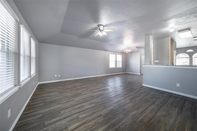 116 Birdbrook Dr, Anna, TX 75409 - unfurnished room featuring ceiling fan with notable chandelier, vaulted ceiling, baseboards, and dark wood-style flooring