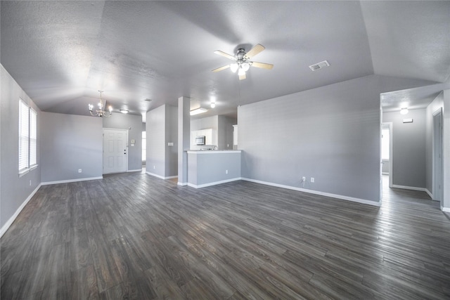 116 Birdbrook Dr, Anna, TX 75409 - unfurnished living room featuring dark wood-type flooring, baseboards, vaulted ceiling, and ceiling fan with notable chandelier