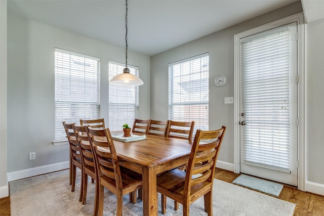 8106 Persimmon St, Irving, TX 75063 - dining area featuring baseboards and light wood-style flooring