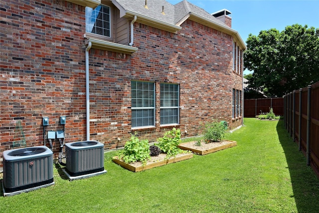 8106 Persimmon St, Irving, TX 75063 - view of property exterior with cooling unit, a vegetable garden, and brick siding