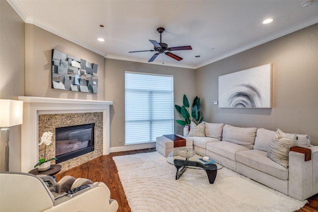 living room featuring recessed lighting, a ceiling fan, ornamental molding, and wood finished floors
