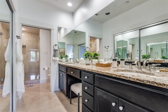 3204 Wycliff Ave Unit 3214, Dallas, TX 75219 - full bath featuring toilet, double vanity, a stall shower, and tile patterned flooring