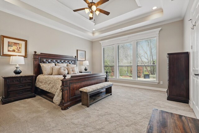 bedroom with light carpet, a raised ceiling, crown molding, baseboards, and ceiling fan