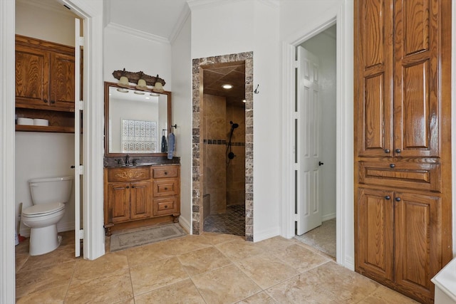 bathroom featuring walk in shower, crown molding, vanity, and toilet