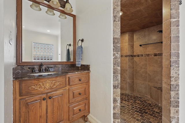 bathroom with a walk in shower and vanity