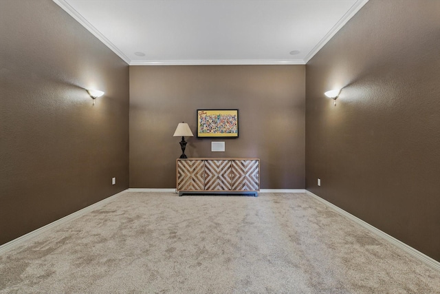 empty room featuring carpet floors, crown molding, and baseboards