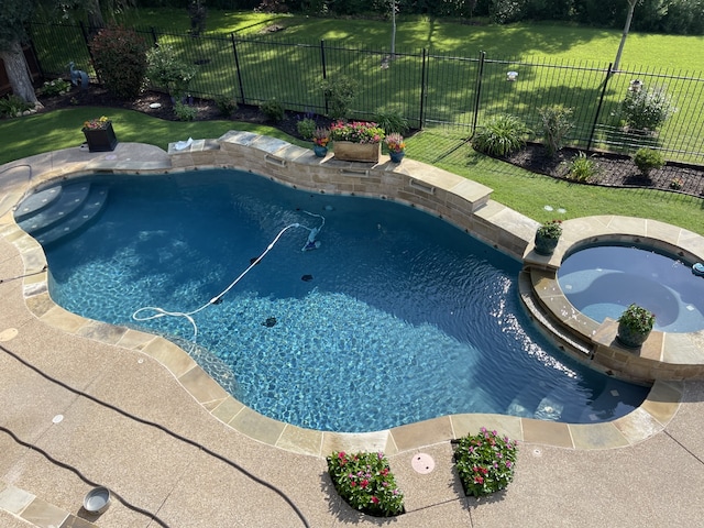view of pool with a pool with connected hot tub