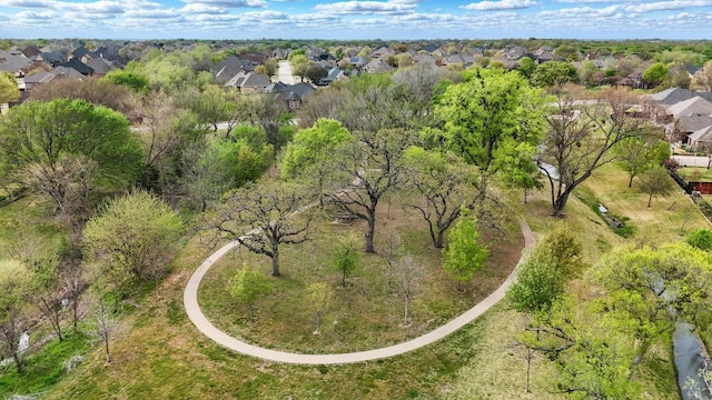 aerial view of property and surrounding area featuring nearby suburban area