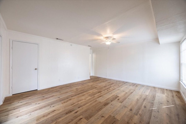 1602 Marion Dr, Garland, TX 75042 - unfurnished room featuring visible vents, light wood-style flooring, baseboards, ceiling fan, and ornamental molding