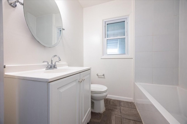 1602 Marion Dr, Garland, TX 75042 - bathroom with baseboards, toilet, and vanity