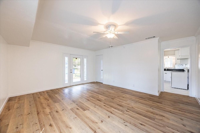 1602 Marion Dr, Garland, TX 75042 - unfurnished living room featuring a ceiling fan, light wood finished floors, baseboards, visible vents, and ornamental molding