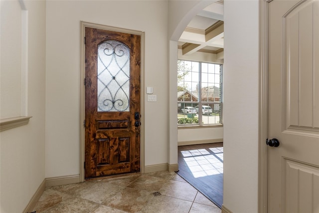 681 Harper Dr, Fate, TX 75087 - foyer featuring healthy amount of natural light, beam ceiling, coffered ceiling, light tile patterned floors, and arched walkways