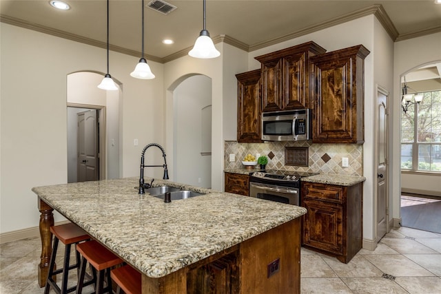 681 Harper Dr, Fate, TX 75087 - kitchen with appliances with stainless steel finishes, a sink, arched walkways, backsplash, and ornamental molding