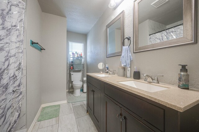 full bath featuring visible vents, toilet, a sink, and a textured ceiling