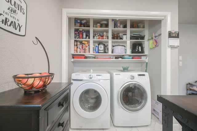 clothes washing area featuring laundry area and washer and clothes dryer