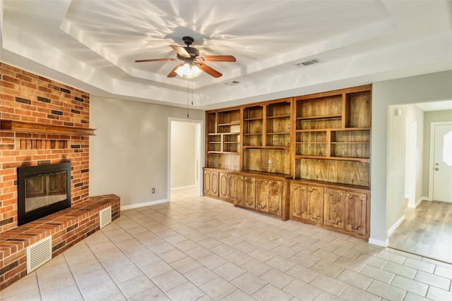 112 Woodcrest St, Weatherford, TX 76087 - unfurnished living room featuring a raised ceiling, light tile patterned floors, a ceiling fan, and baseboards