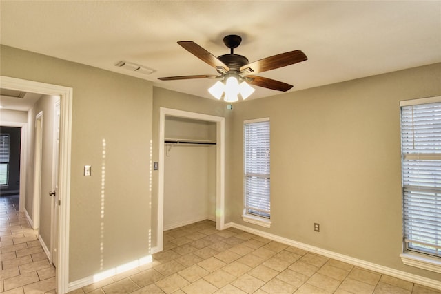 112 Woodcrest St, Weatherford, TX 76087 - unfurnished bedroom featuring a closet, baseboards, light tile patterned floors, and a ceiling fan